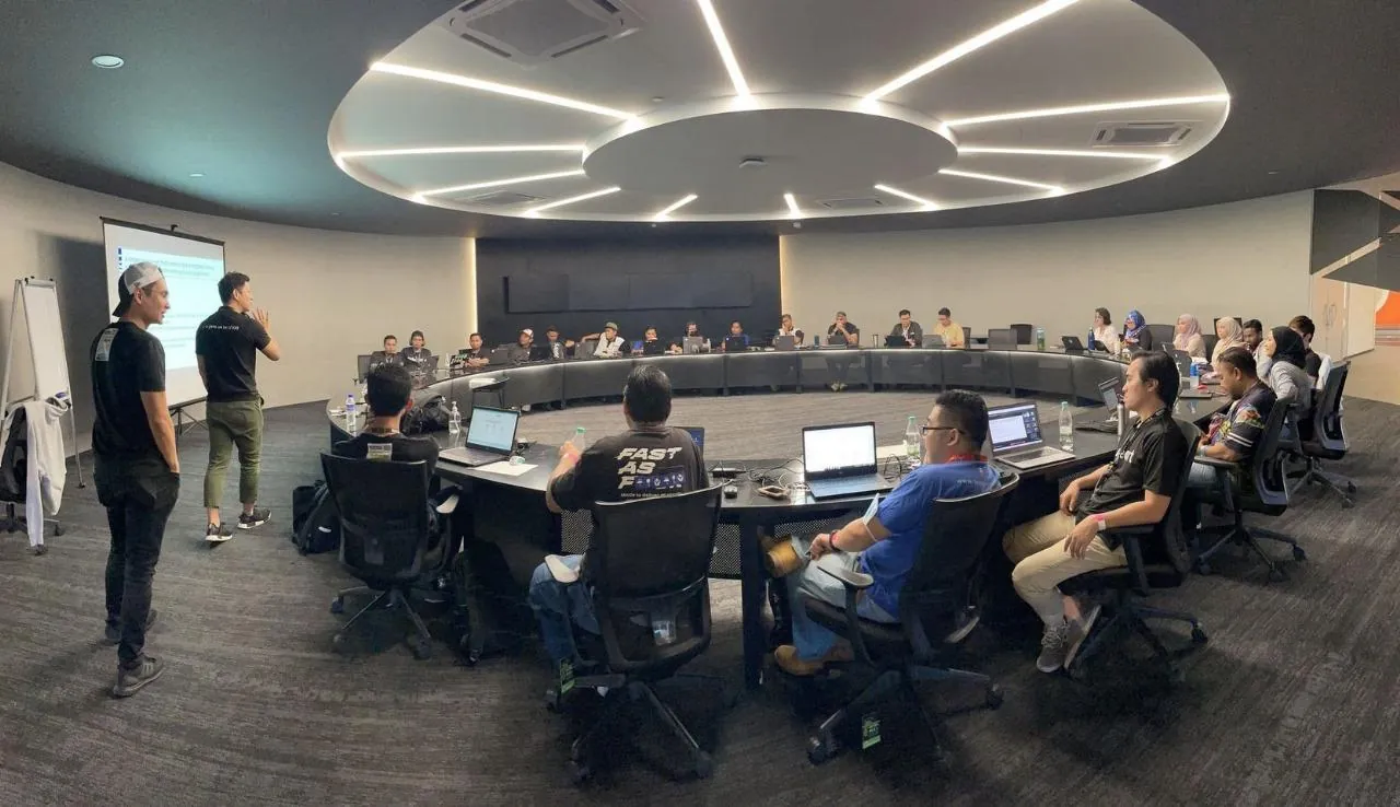A briefing room at an airline, with the team presenting to staff working at laptops