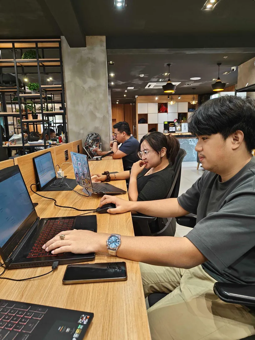 Members of the operations team at laptops in the office