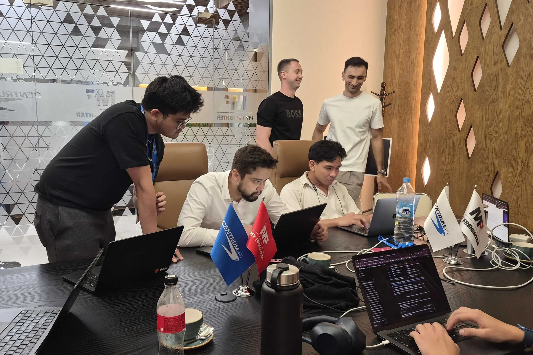 The Belli and My Freighter teams working together on laptops